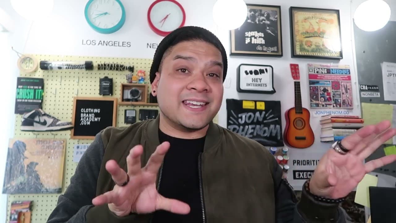 Man gesturing while explaining CMYK vs RGB color differences in studio setting