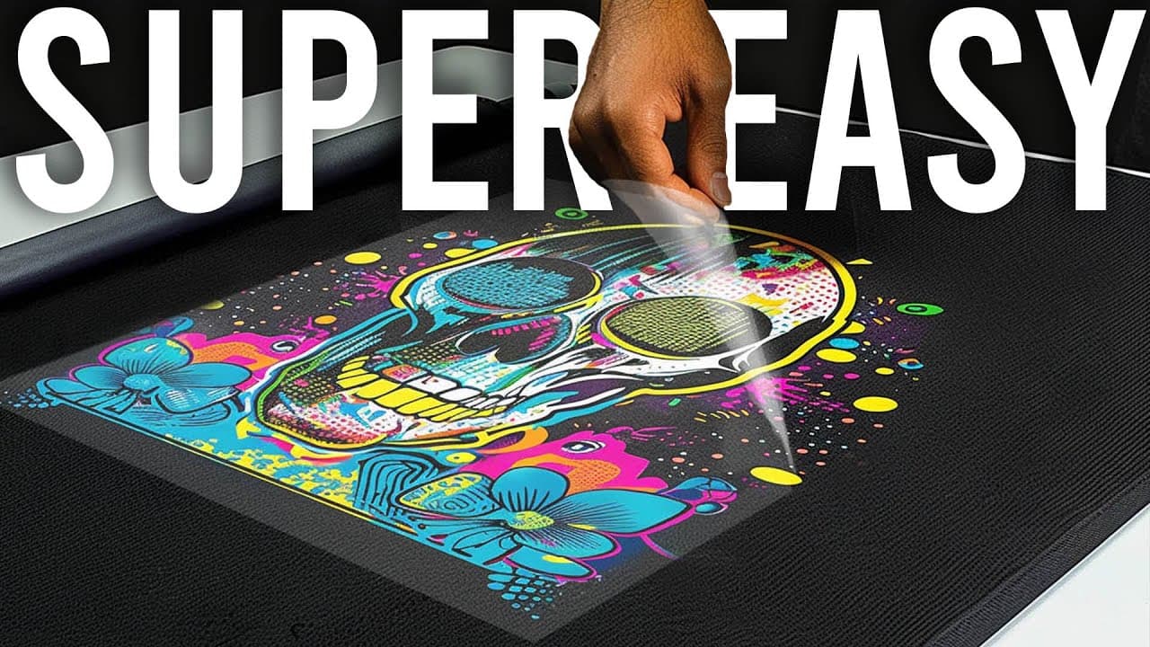 Hand applying colorful direct-to-garment print design onto black t-shirt using Supacolor technology