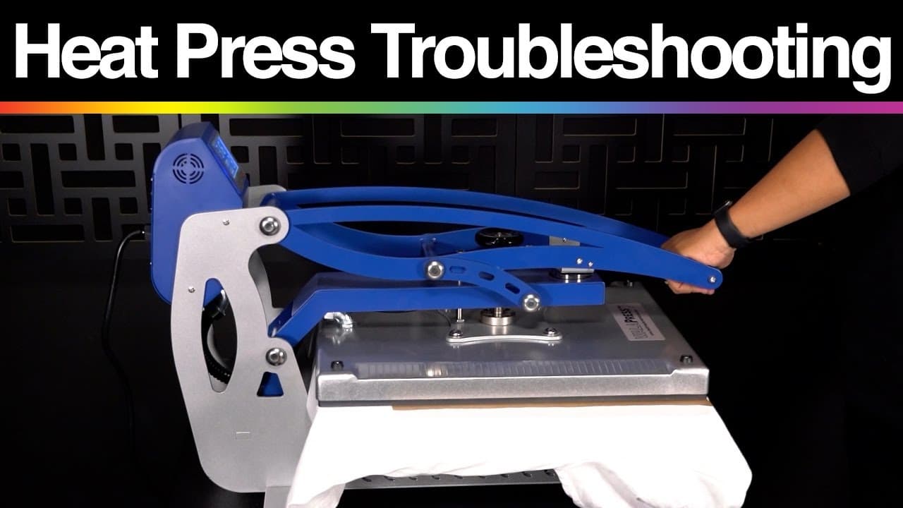 Blue and white heat press machine with operator demonstrating troubleshooting technique