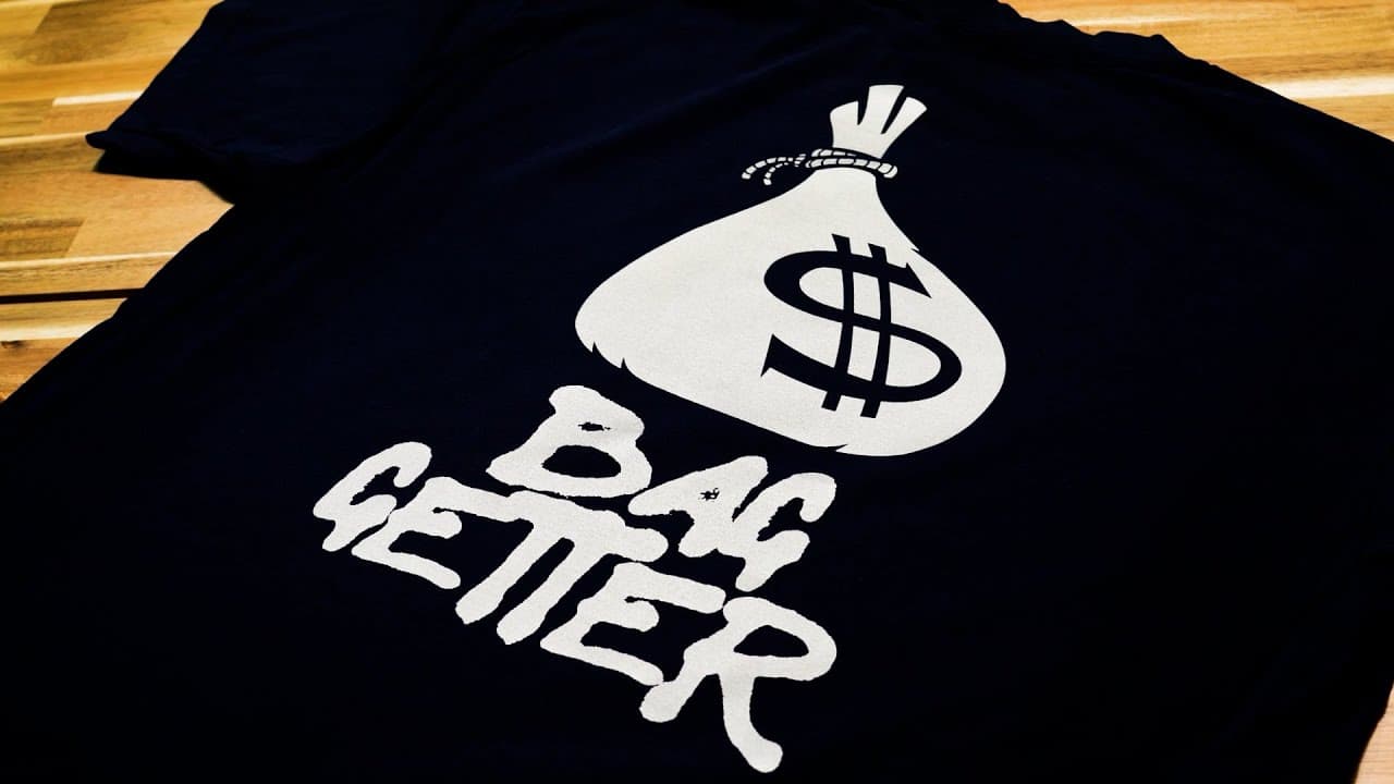 Black t-shirt with white reflective money bag and "Getting Paper" text heat transfer design