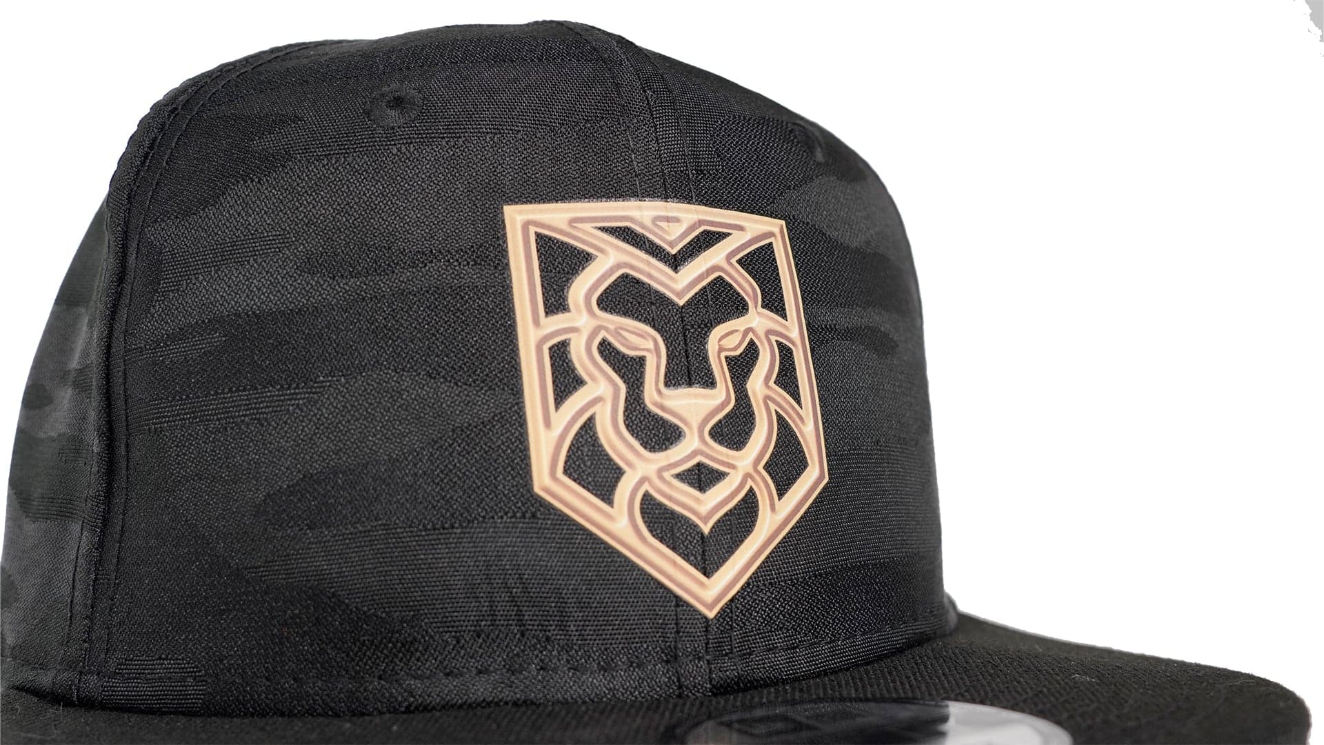 Black snapback cap with gold lion head heat press decoration on back panel