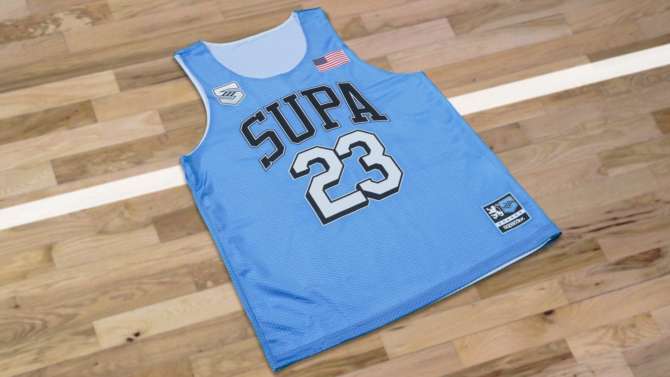 Blue Supra basketball jersey number 23 on wooden floor demonstrating lo melt blocker transfer application